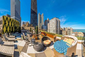a rooftop patio with a view of the city and the ocean
